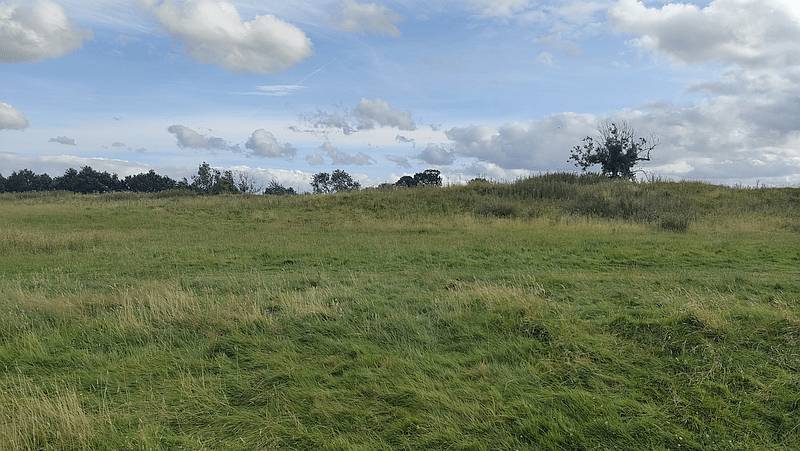 A grassy plain where Hadrian's Wall once stood